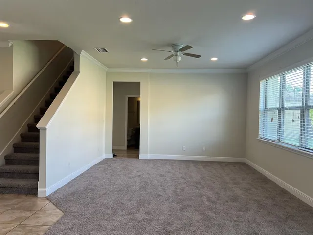 an empty room with windows and closet