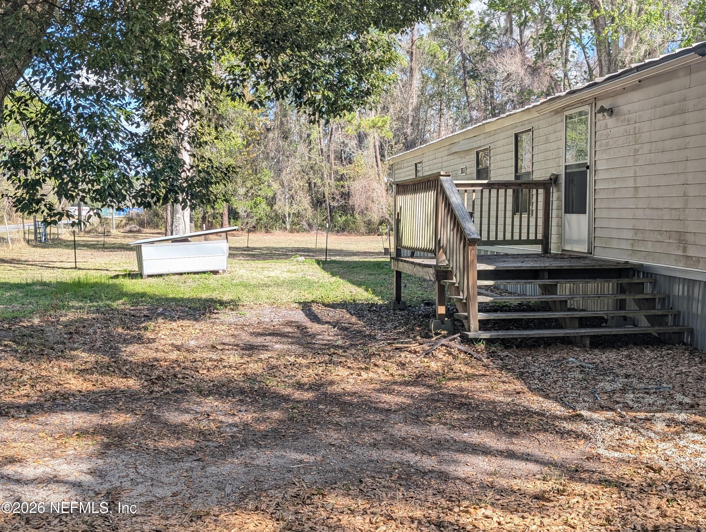 114 Durden Road Interlachen, FL 32148 - Photo 19 of 30 a view of a yard with wooden fence