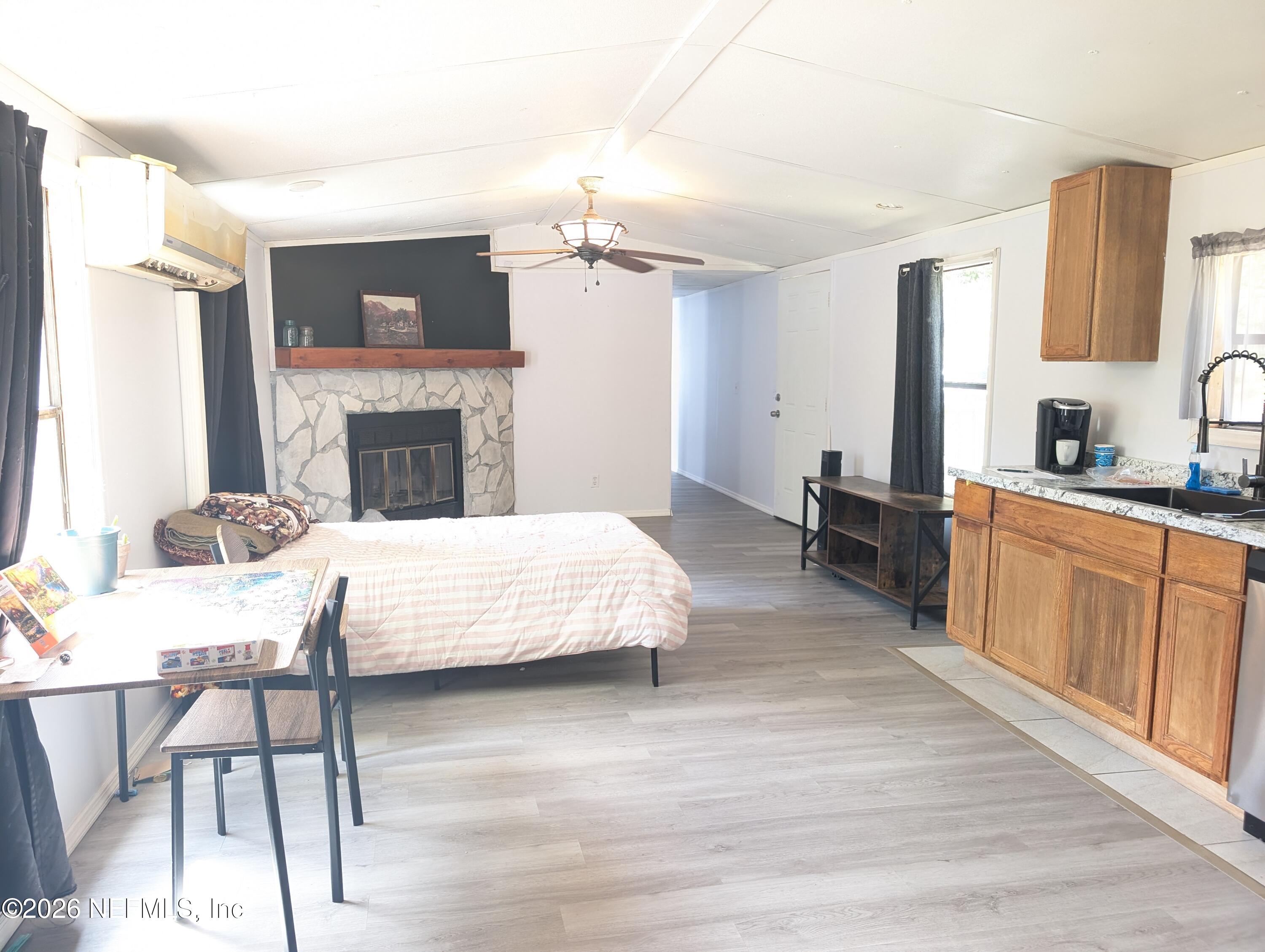 114 Durden Road Interlachen, FL 32148 - Photo 2 of 30 a spacious bedroom with a bed and a fireplace