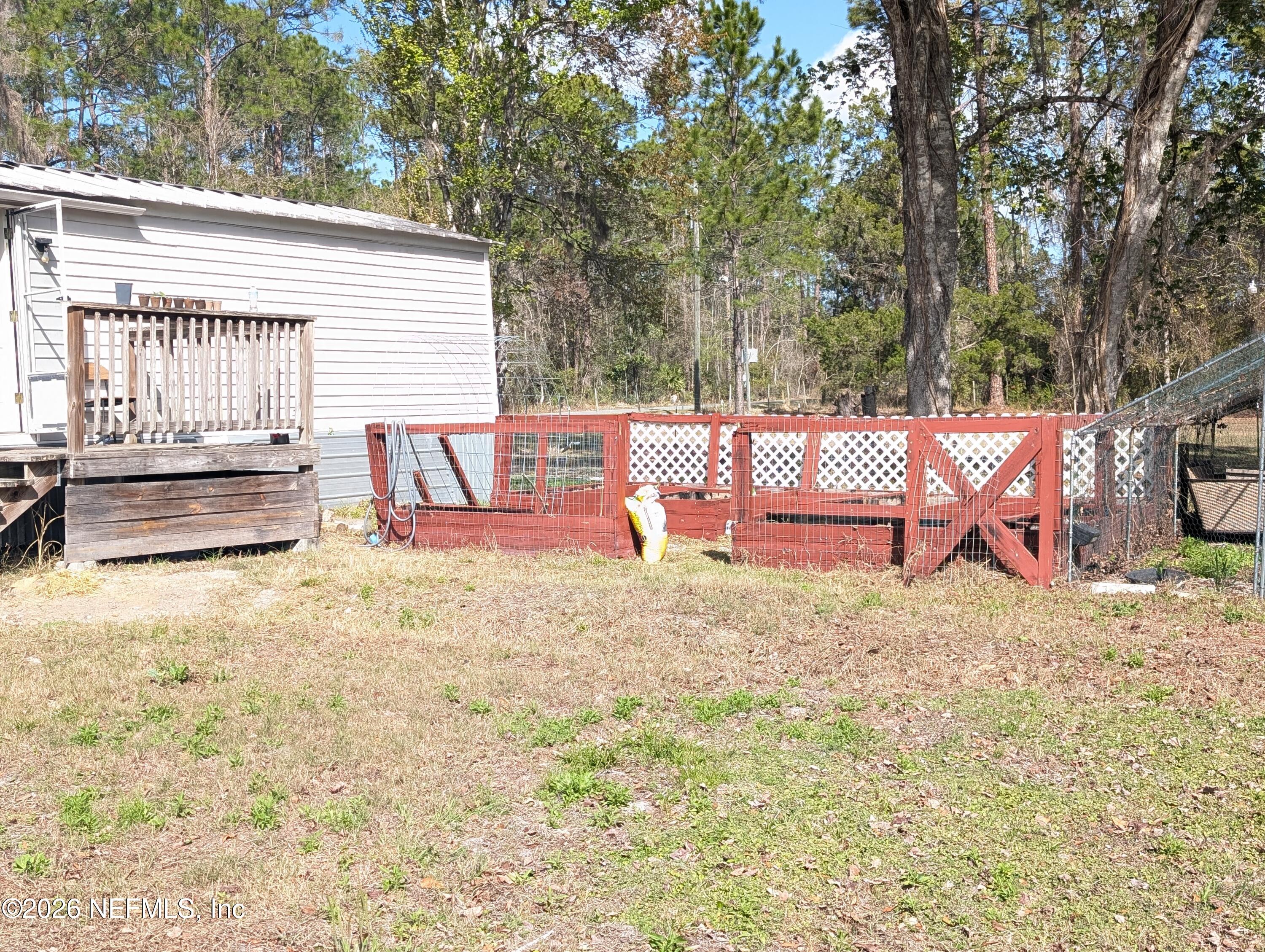 114 Durden Road Interlachen, FL 32148 - Photo 21 of 30 a view of backyard and tree