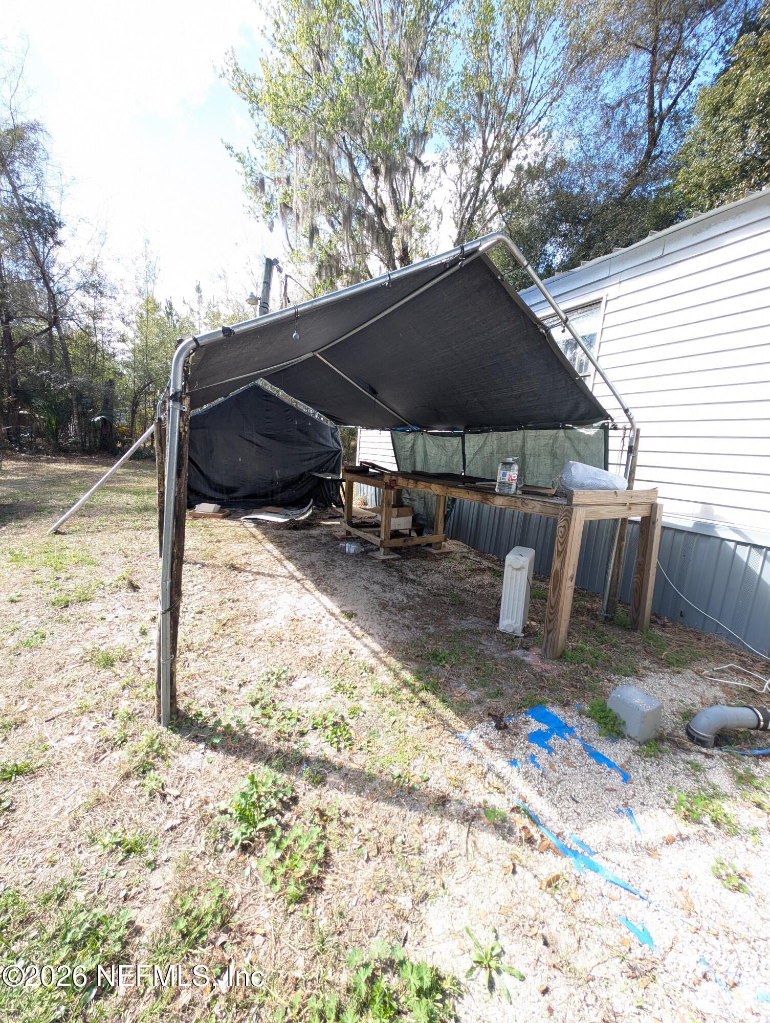 114 Durden Road Interlachen, FL 32148 - Photo 22 of 30 a backyard of a house with table and chairs