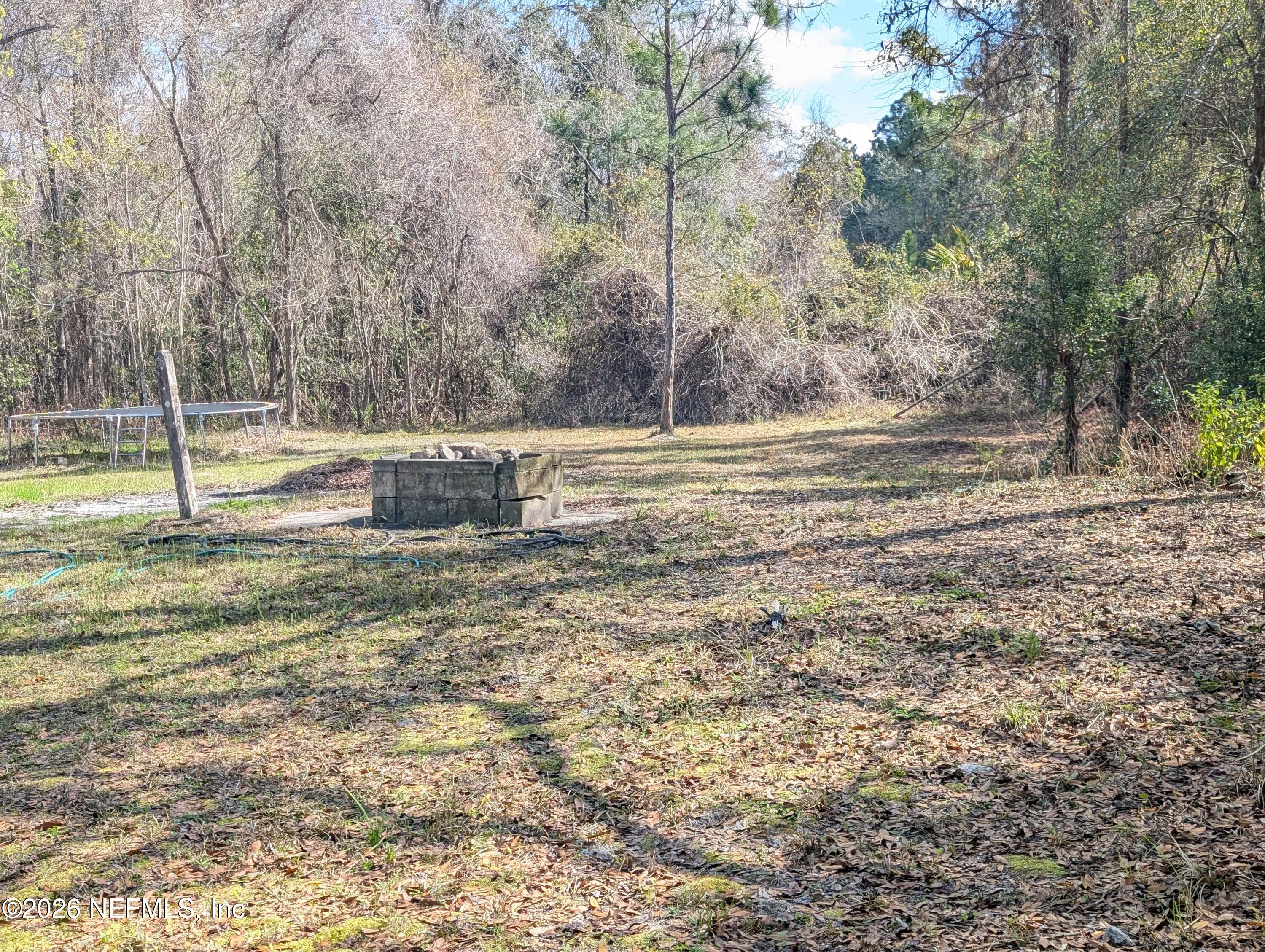 114 Durden Road Interlachen, FL 32148 - Photo 28 of 30 a backyard of a house with trees and houses