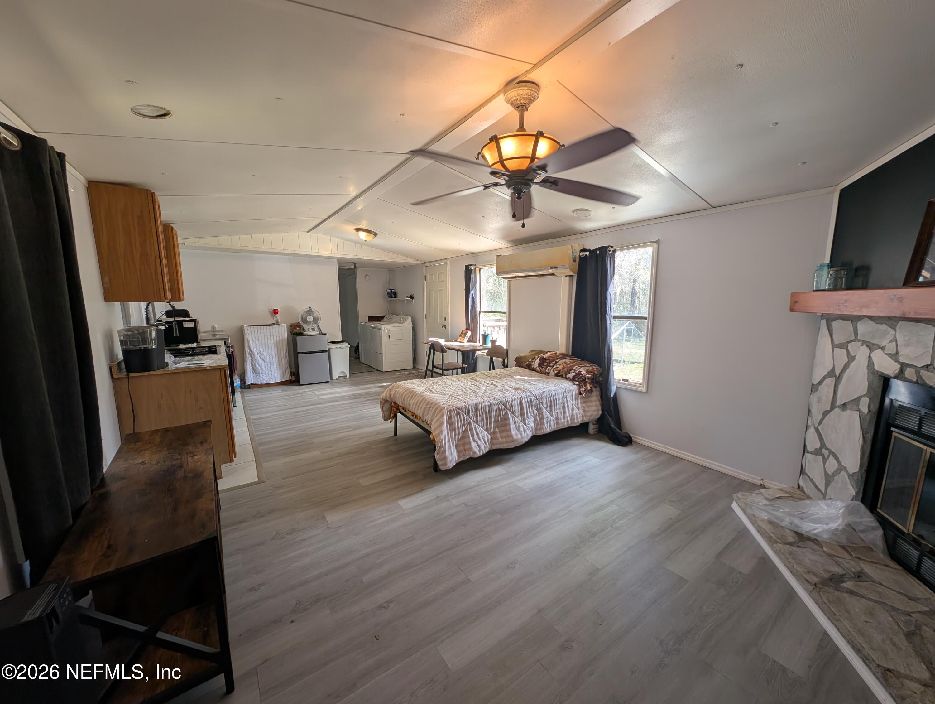 114 Durden Road Interlachen, FL 32148 - Photo 3 of 30 a spacious bedroom with a bed and a flat screen tv