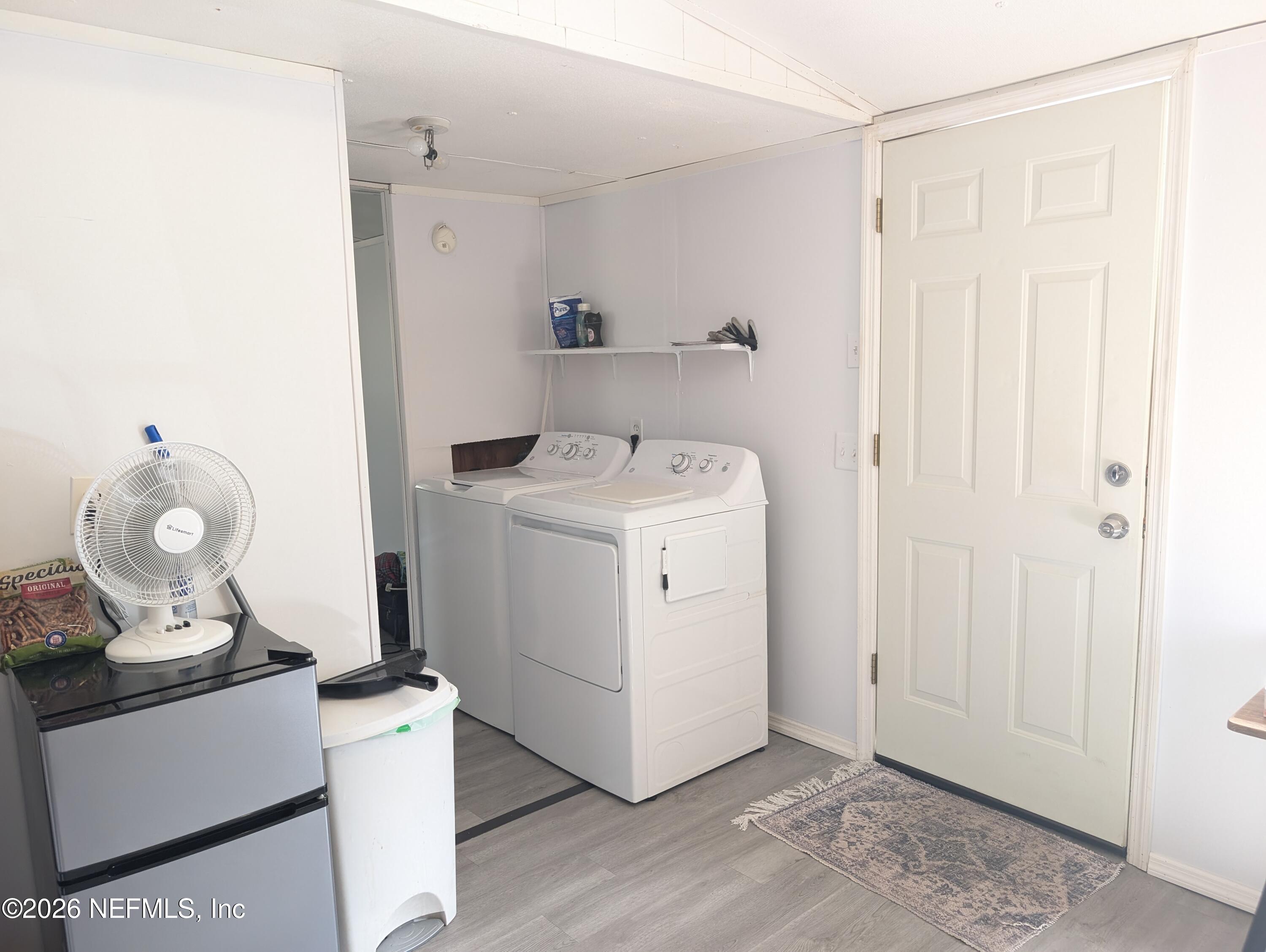 114 Durden Road Interlachen, FL 32148 - Photo 7 of 30 a utility room with cabinets washer and dryer