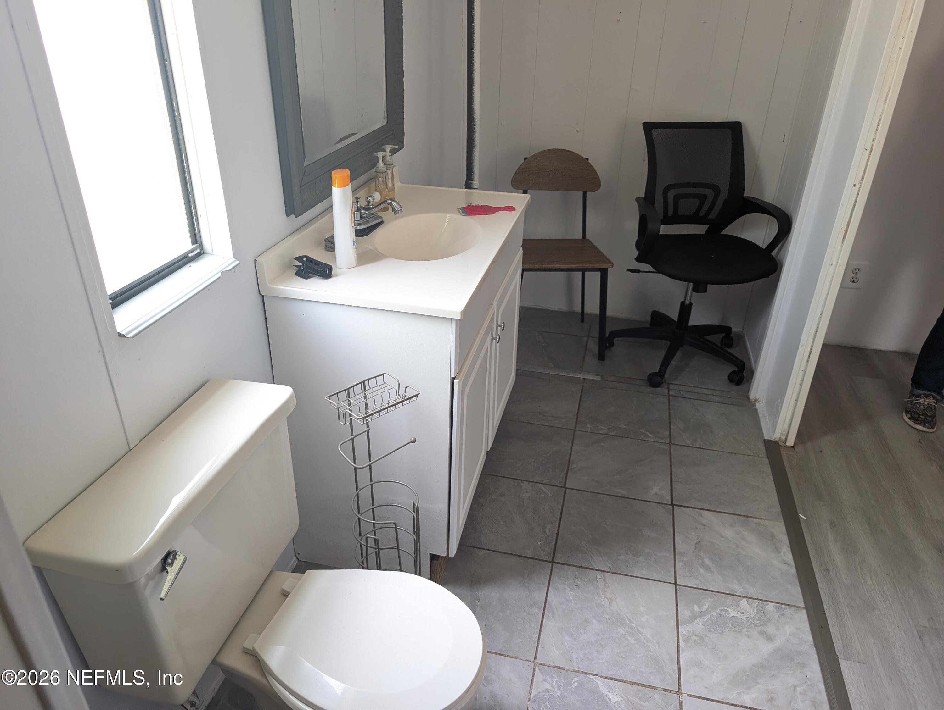 114 Durden Road Interlachen, FL 32148 - Photo 9 of 30 a bathroom with a sink a toilet and a mirror