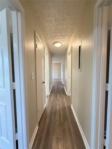 a view of hallway with wooden floor