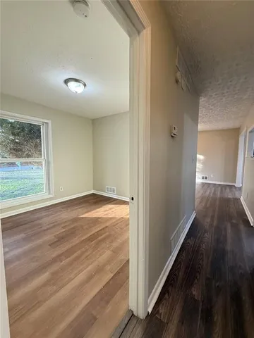 a view of a room with wooden floor
