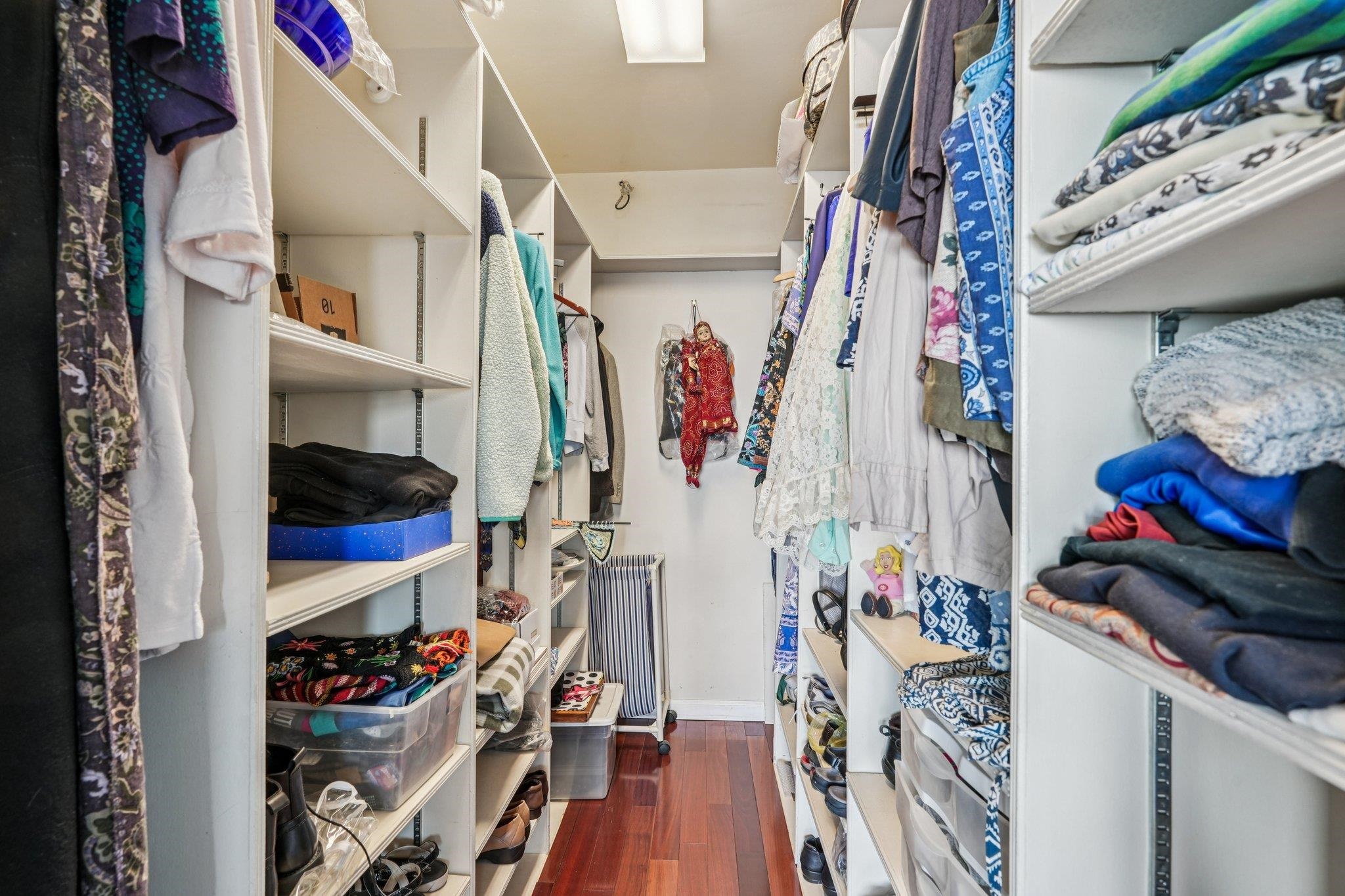 6040 Boulevard East, Unit 23G West New York, NJ 07093 - Photo 18 of 32 a view of walk in closet with clothes and shoes