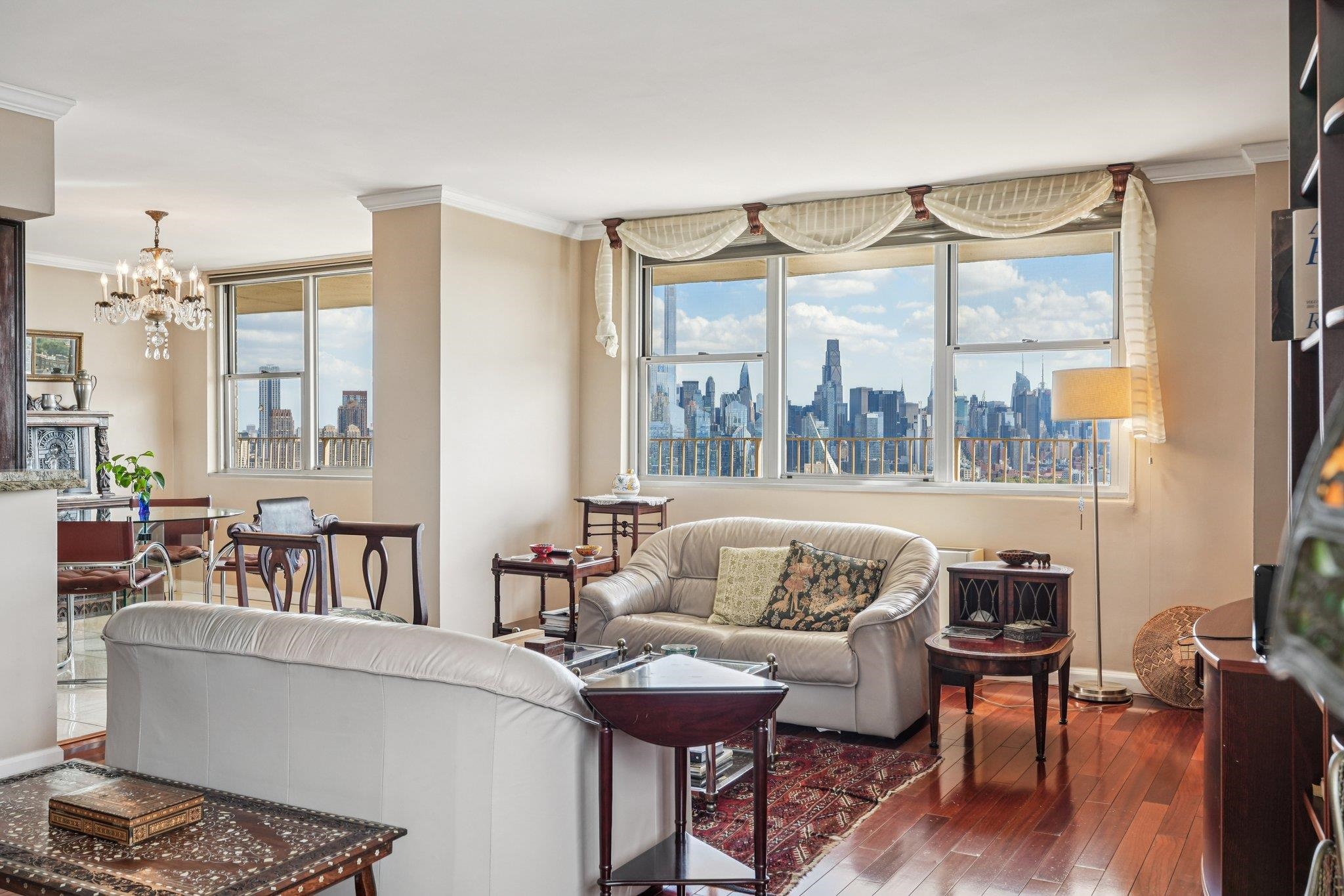 6040 Boulevard East, Unit 23G West New York, NJ 07093 - Photo 3 of 32 a living room with furniture and a large window