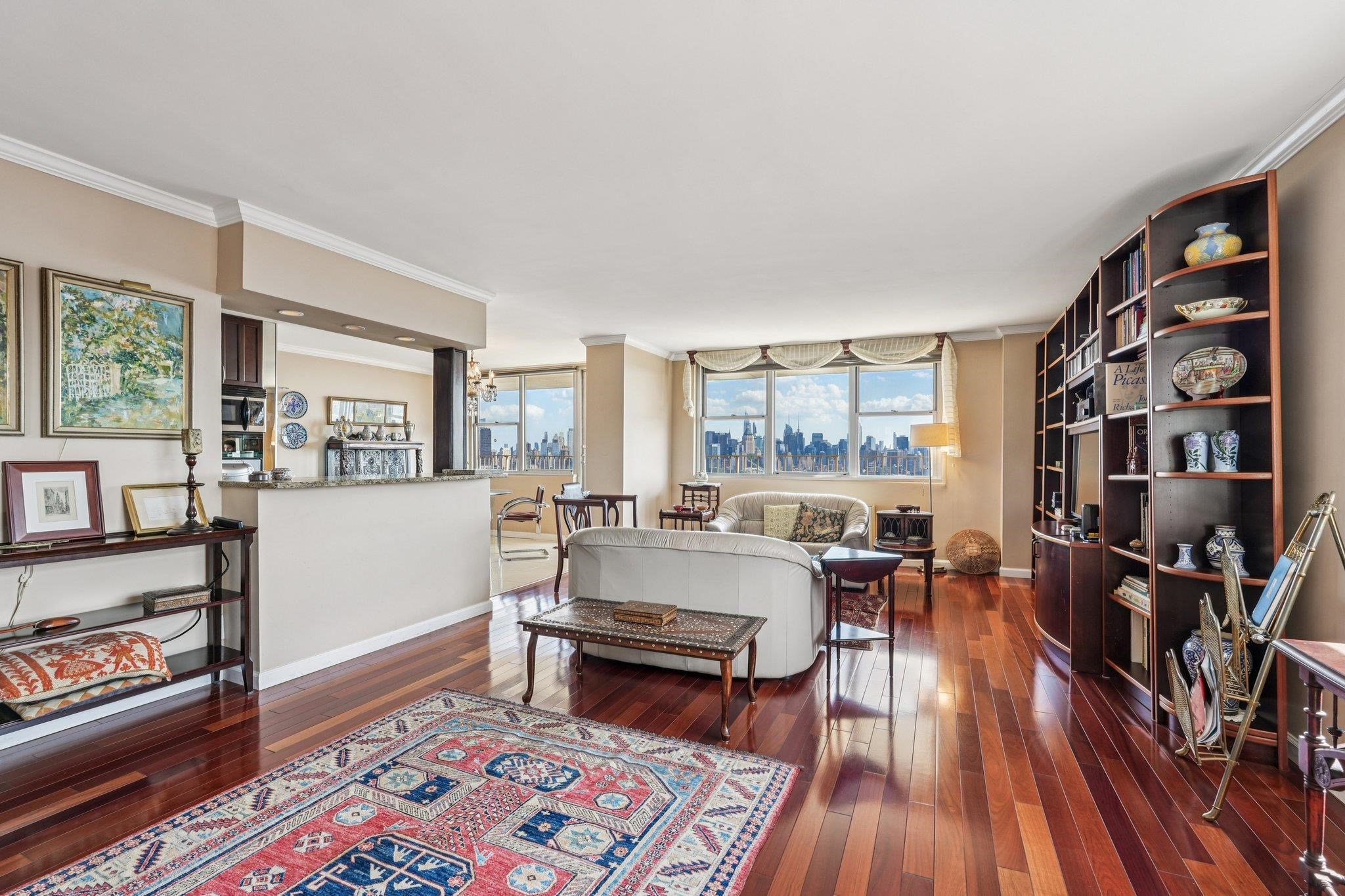6040 Boulevard East, Unit 23G West New York, NJ 07093 - Photo 4 of 32 a living room with furniture and a wooden floor