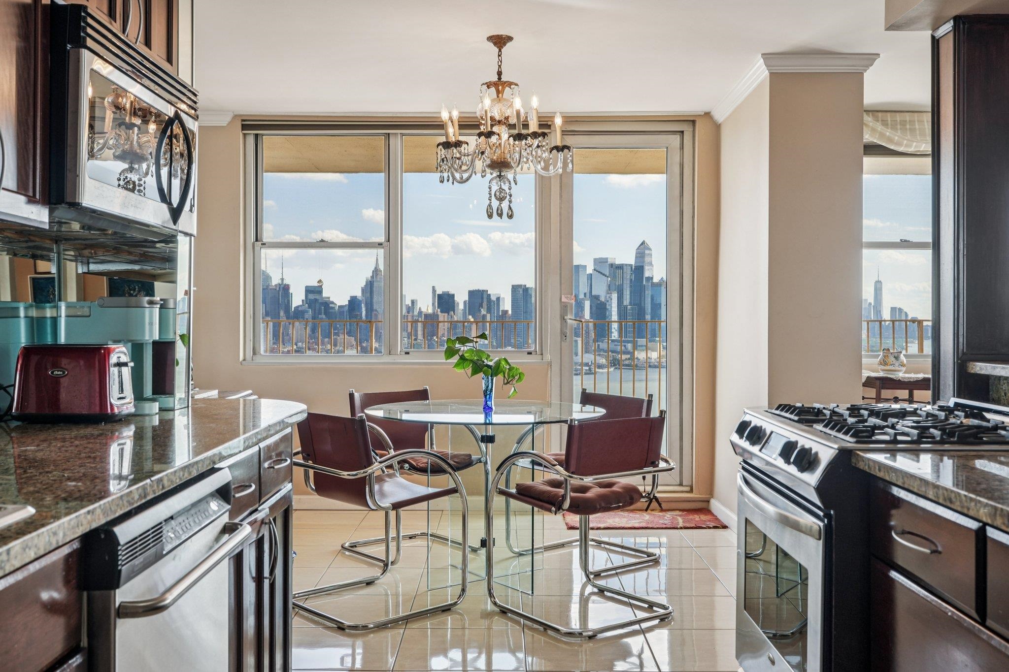 6040 Boulevard East, Unit 23G West New York, NJ 07093 - Photo 10 of 32 a dining table tennis with a chandelier