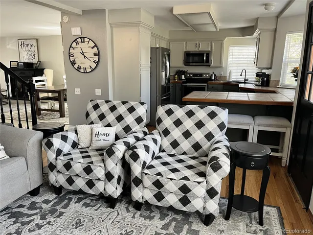 a living room with furniture and a large mirror
