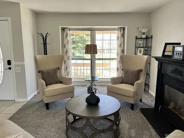 a living room with furniture and a fireplace