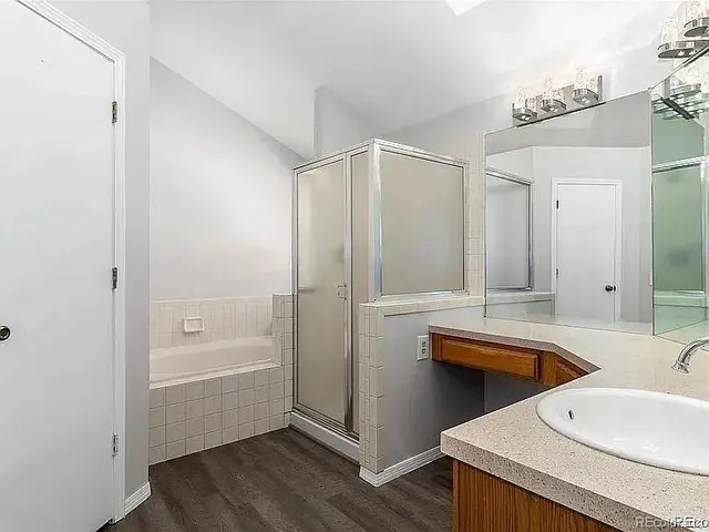 a bathroom with a sink a mirror and a bathtub