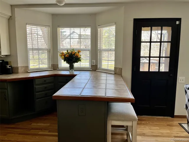 a room with pool table and windows
