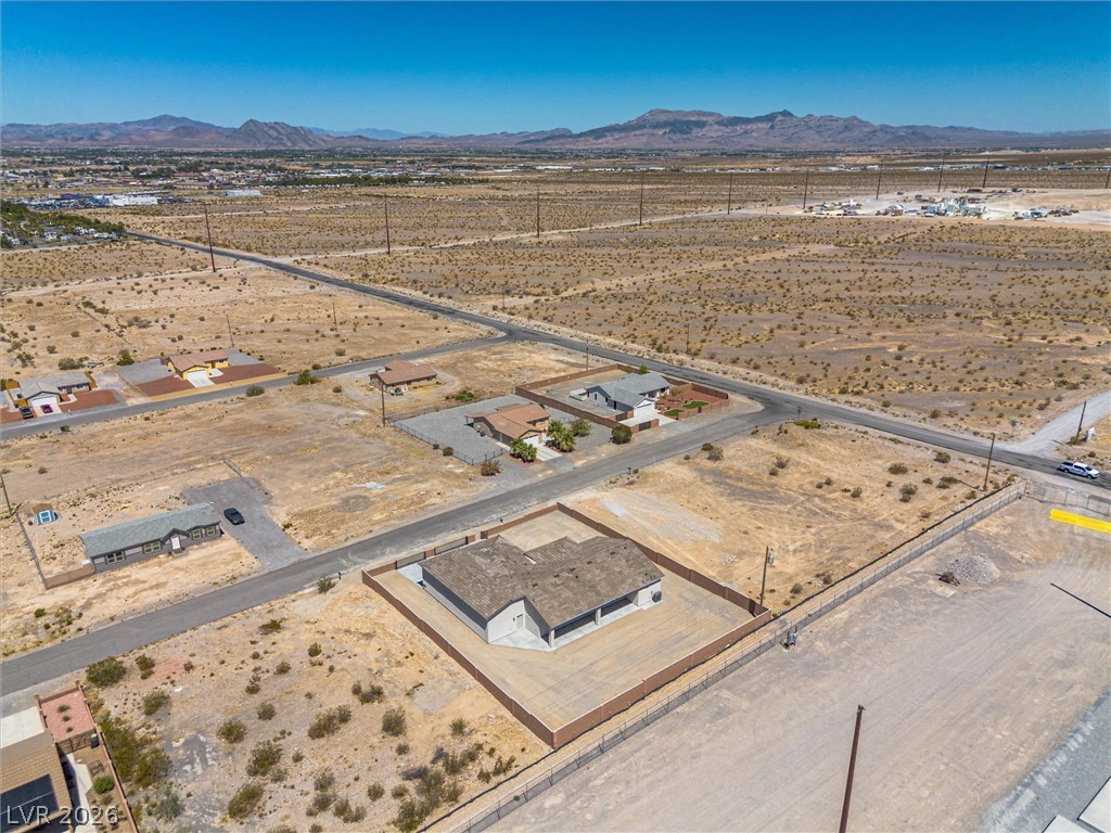 1061 Factory Road Pahrump, NV 89048 - Photo 39 of 41 An aerial perspective reveals a vast, open desert landscape with a single-story residence securely fenced.