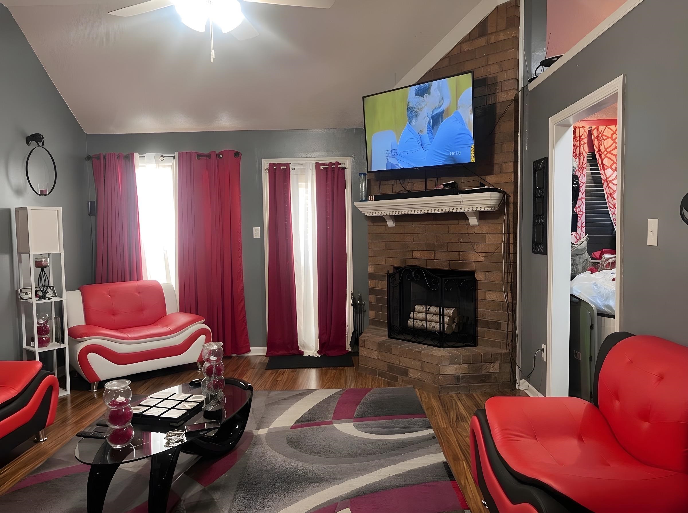 4005 Long Creek Road Memphis, TN 38125 - Photo 12 of 37 Living room with lofted ceiling, a ceiling fan, dark wood finished floors, and a brick fireplace
