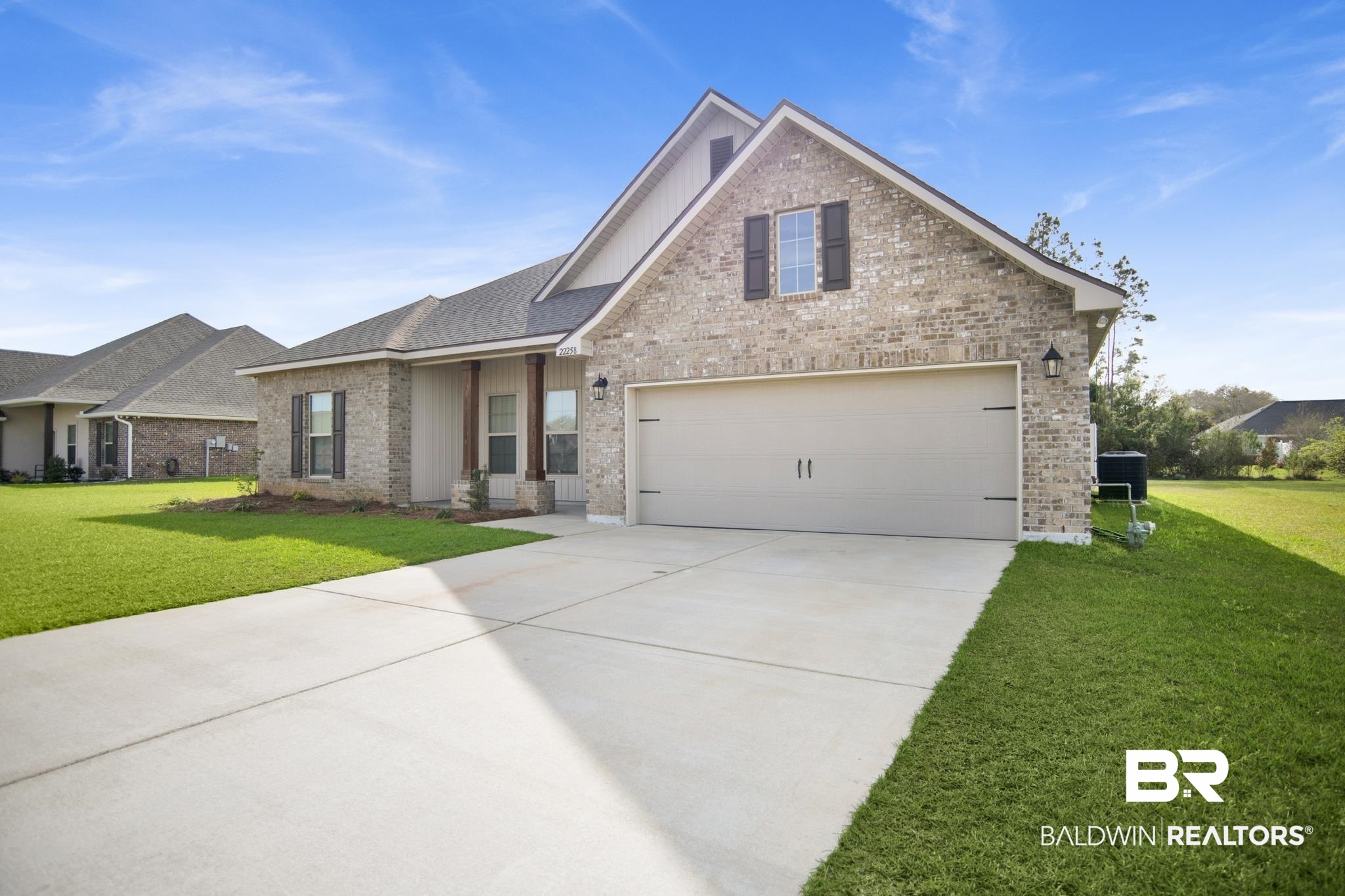 22258 Hibiscus Circle Foley, AL 36535 - Photo 1 of 26 View of front of property featuring brick siding, a garage, driveway, and a front lawn