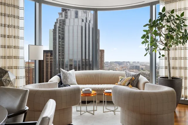 a living room with furniture and a potted plant