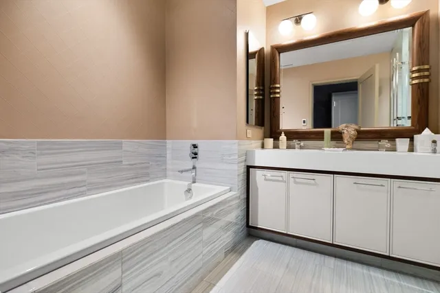 a bathroom with a bathtub and a sink