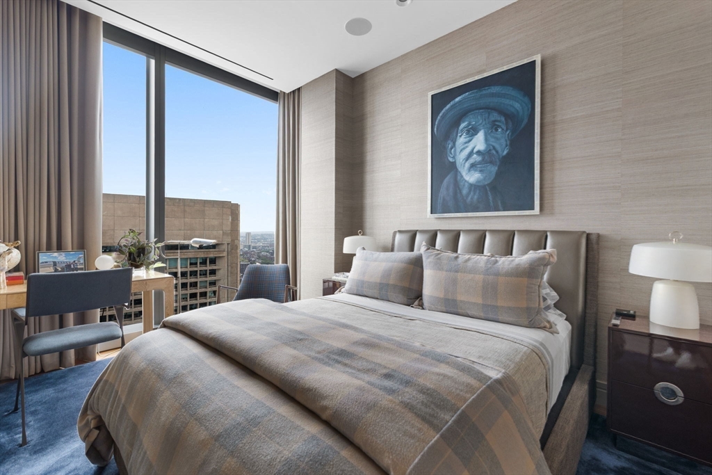 1 Dalton Street, Unit 3003 Boston, MA 02115 - Photo 12 of 24 a bedroom with a bed a lamp and a large window