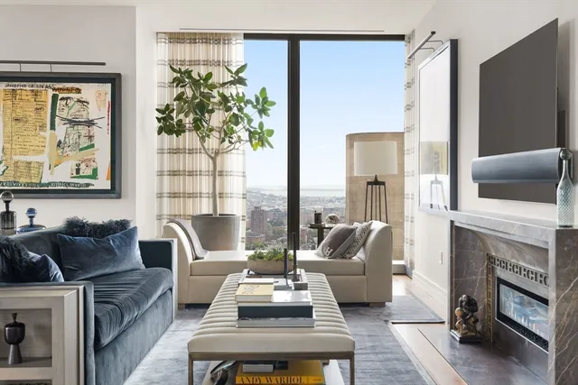 a living room with furniture fireplace and flat screen tv