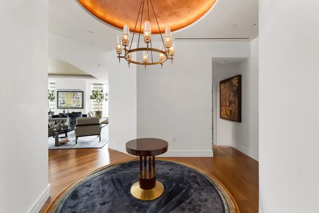a view of a livingroom with furniture and a chandelier