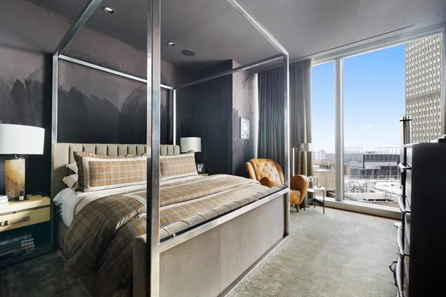 a bed room with a bed and large window