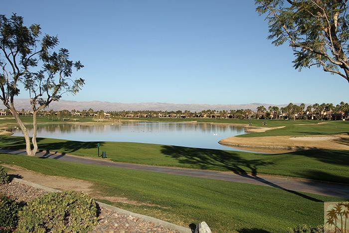 a view of a lake with houses in the back