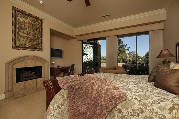 57990 Troon La Quinta, CA 92253 - Photo 12 of 30 a large bedroom with a bed and a fireplace