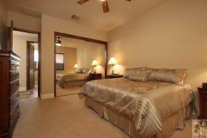 57990 Troon La Quinta, CA 92253 - Photo 23 of 30 a spacious bedroom with a bed and a large mirror