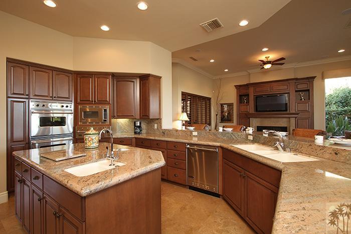 57990 Troon La Quinta, CA 92253 - Photo 5 of 30 a kitchen with stainless steel appliances granite countertop a sink stove and refrigerator
