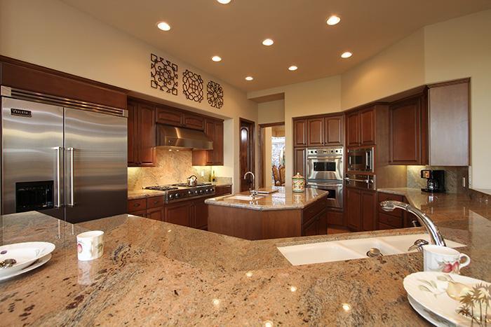 57990 Troon La Quinta, CA 92253 - Photo 6 of 30 a large kitchen with kitchen island a large island in the center