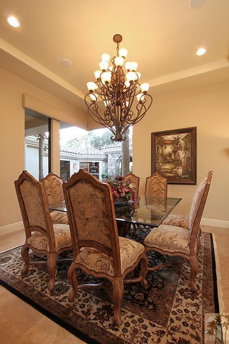 57990 Troon La Quinta, CA 92253 - Photo 8 of 30 a living room with furniture a chandelier and a dining table