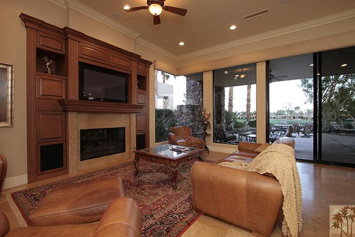 57990 Troon La Quinta, CA 92253 - Photo 10 of 30 a living room with furniture a fireplace and a flat screen tv