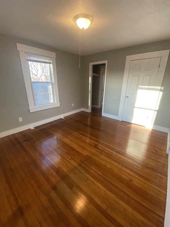 56 Exposition Terrace West Springfield, MA 01089 - Photo 14 of 16 a view of an empty room with window and wooden floor
