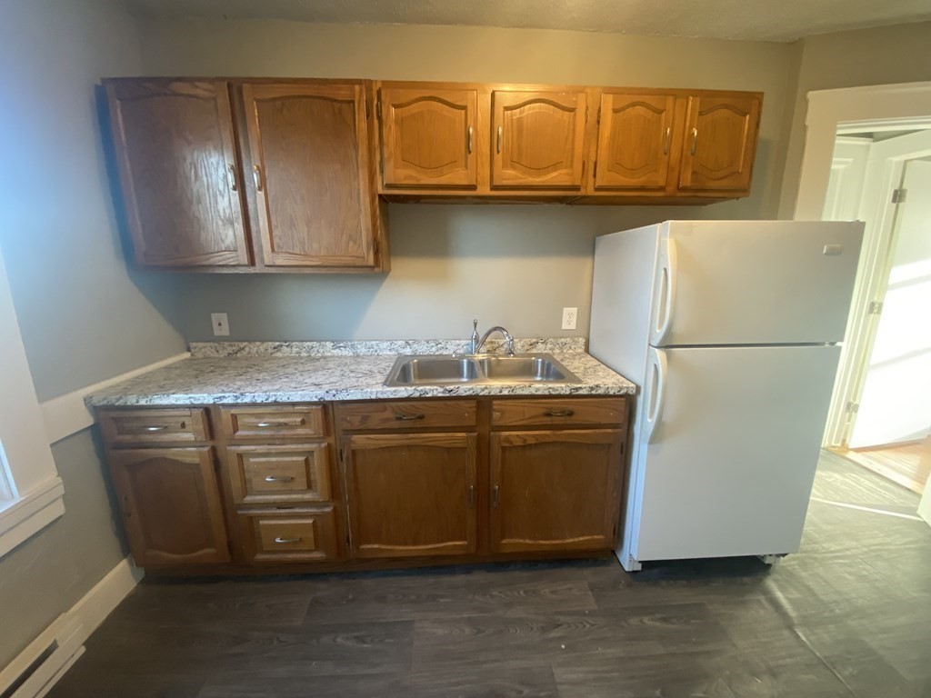 56 Exposition Terrace West Springfield, MA 01089 - Photo 5 of 16 a kitchen with stainless steel appliances granite countertop a refrigerator a stove and a sink with wooden cabinets