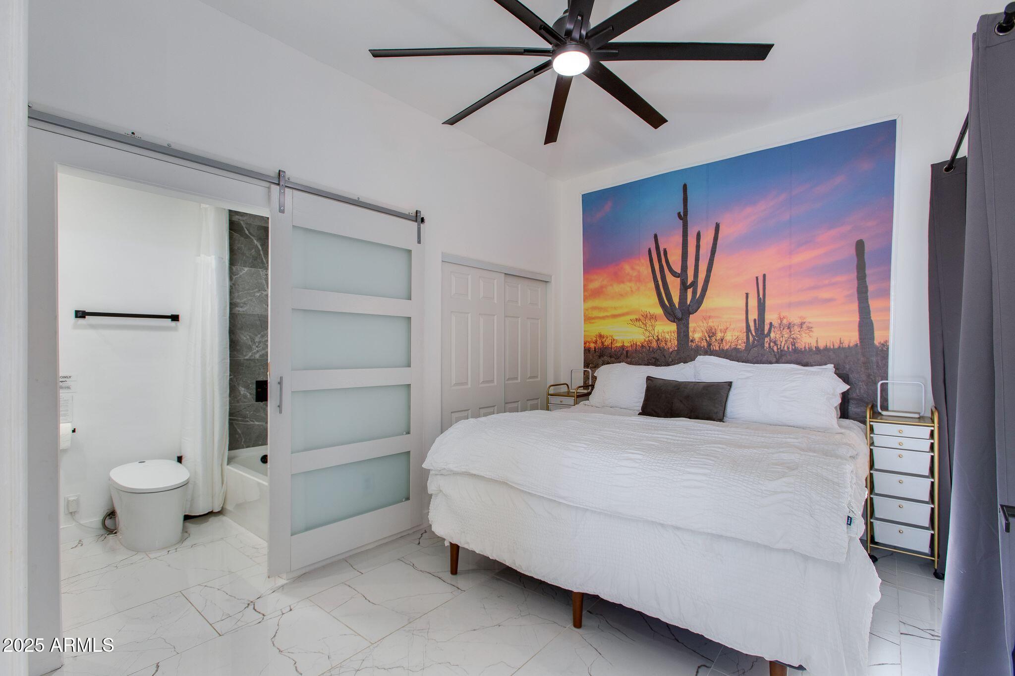 8245 East Bell Road, Unit 150 Scottsdale, AZ 85260 - Photo 8 of 12 a bedroom with a bed and a painting on the wall
