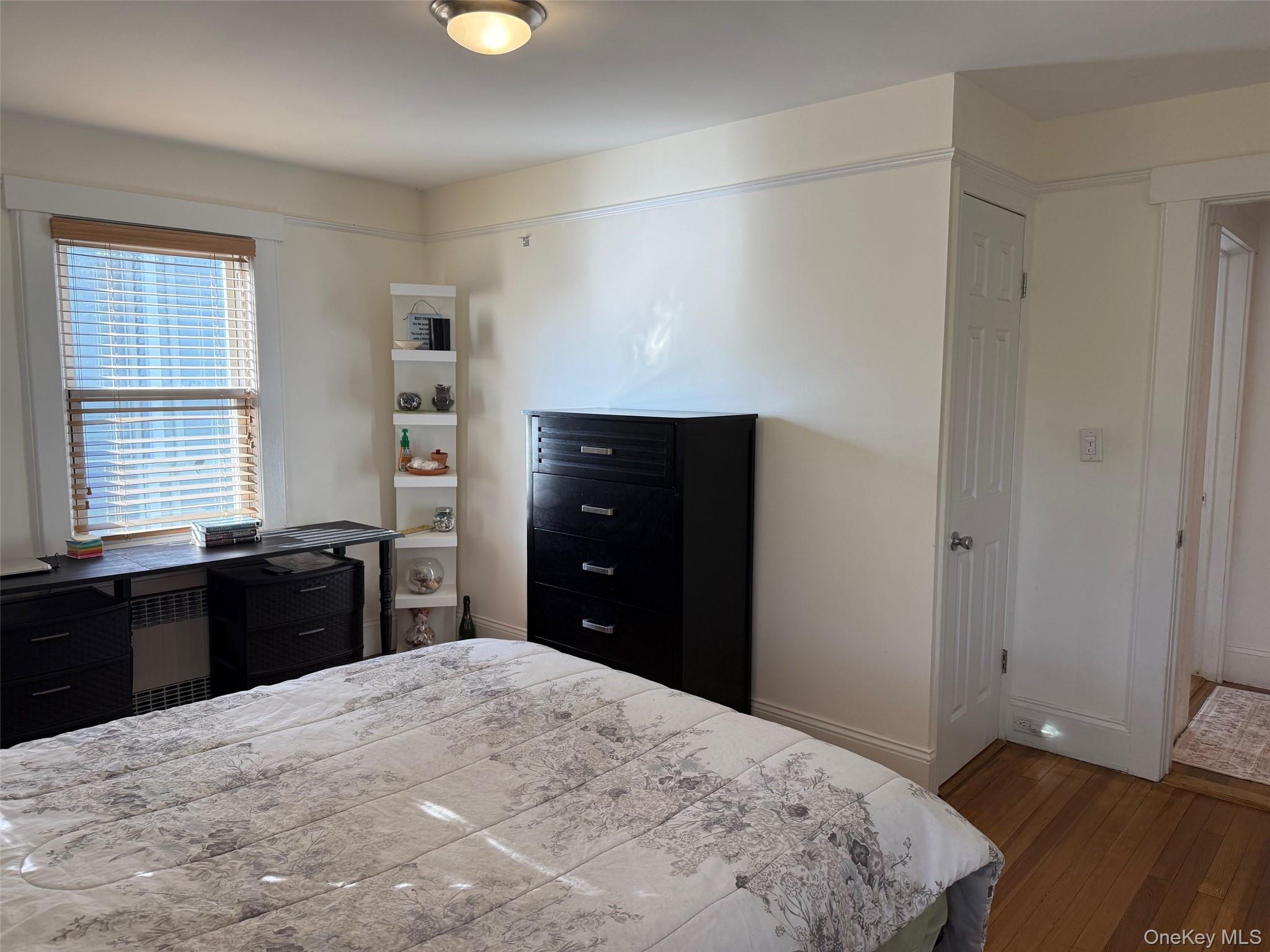 25 School Street Port Washington, NY 11050 - Photo 15 of 25 Bedroom with radiator heating unit and hardwood / wood-style flooring
