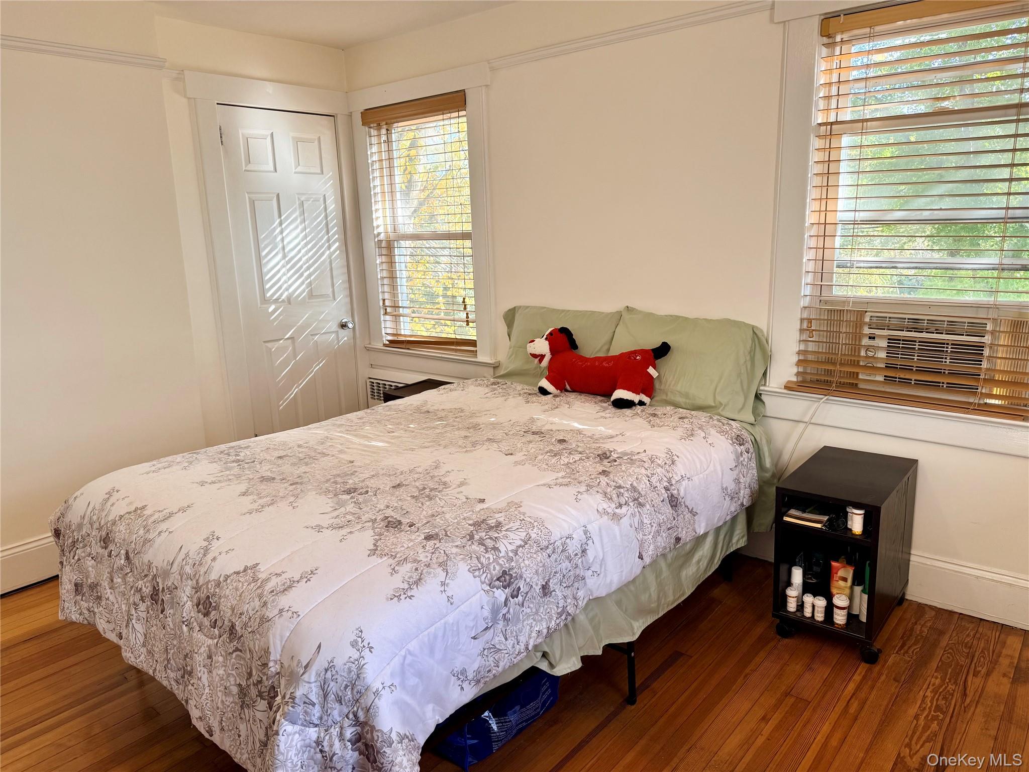 25 School Street Port Washington, NY 11050 - Photo 16 of 25 Bedroom featuring dark wood finished floors and cooling unit