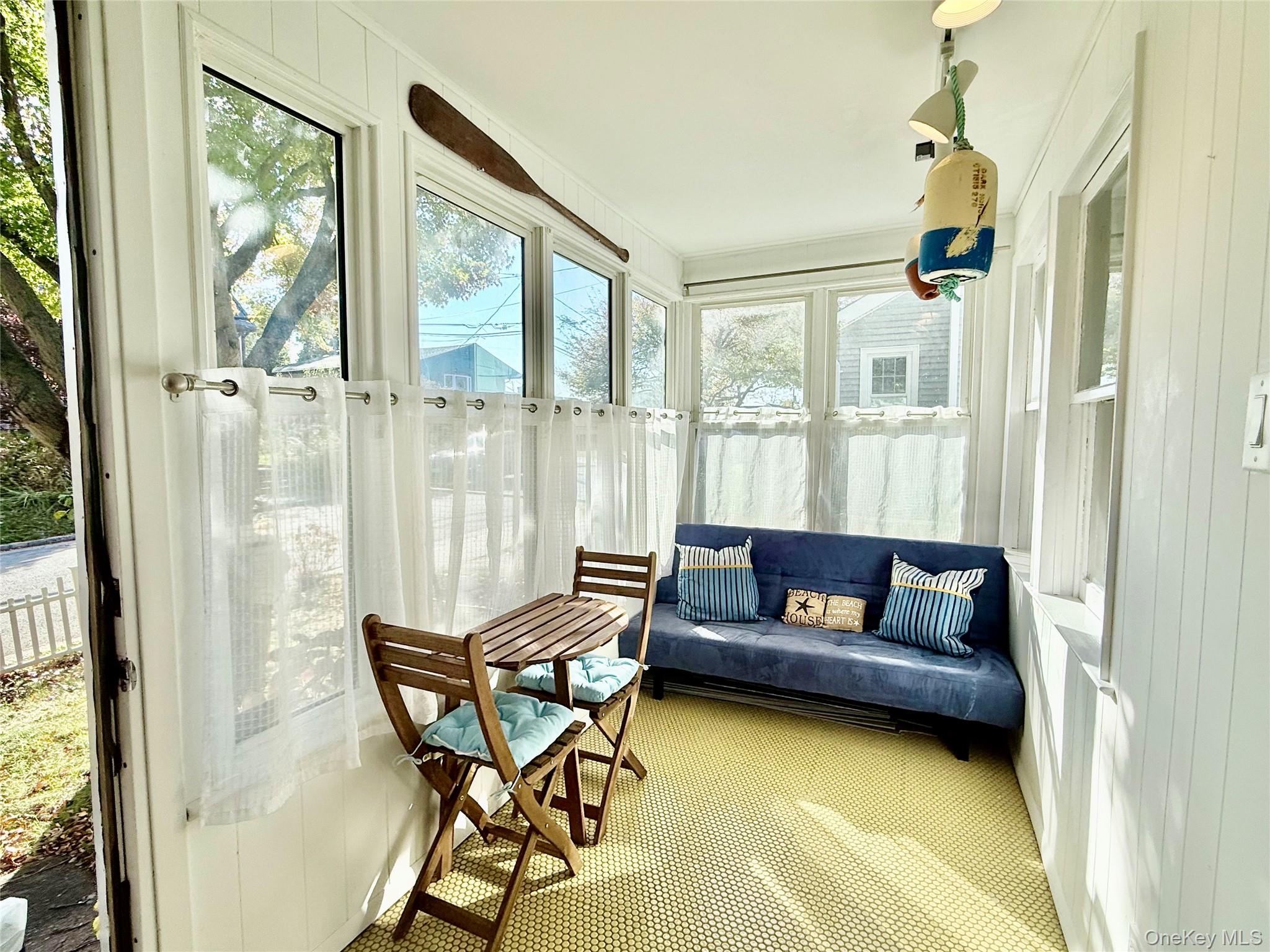 25 School Street Port Washington, NY 11050 - Photo 4 of 25 Enclosed front porch / solarium with carpet and wood walls
