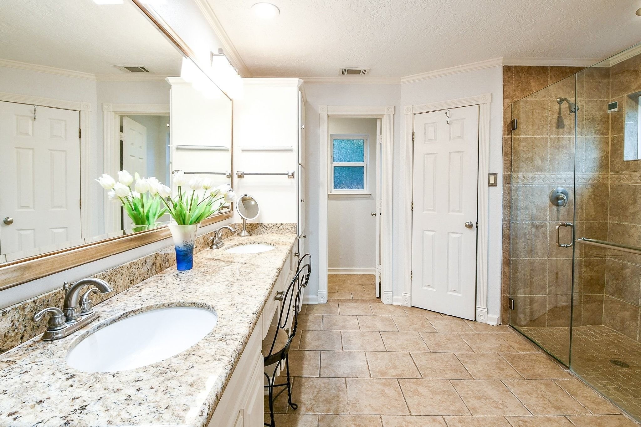 6607 Misty Springs Lane Spring, TX 77379 - Photo 13 of 31 Luxurious bathroom featuring dual sinks and a modern, upgraded shower.