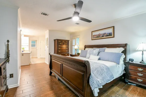 a spacious bedroom with a bed and a chandelier