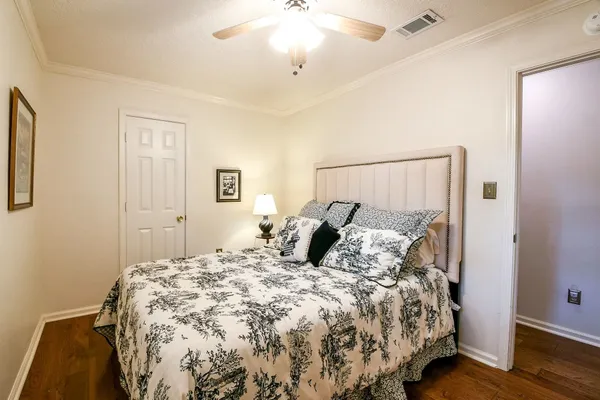 a bedroom with a large bed and a chandelier