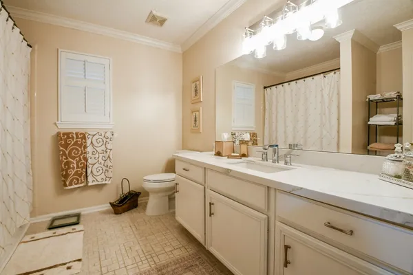 a bathroom with a sink double vanity and a toilet