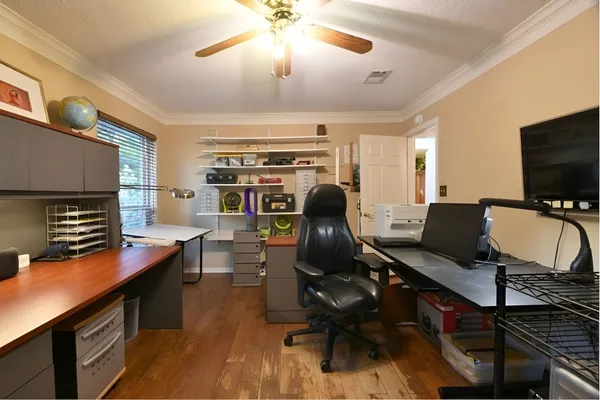 a view of a workspace with furniture and a flat screen tv