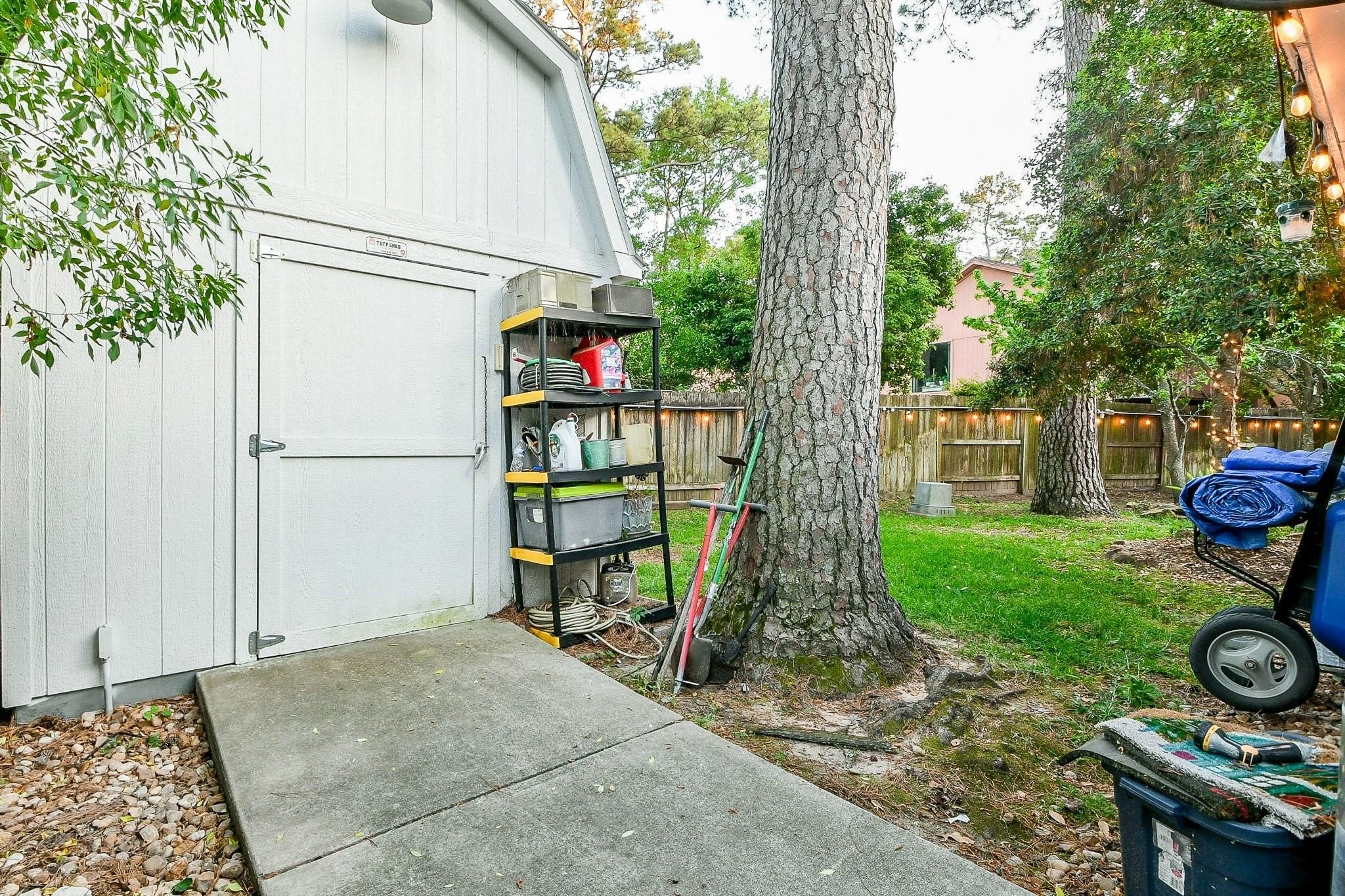 6607 Misty Springs Lane Spring, TX 77379 - Photo 30 of 31 The workroom features an oversized door with convenient access for your golf cart, dune buggy, or children's toys.