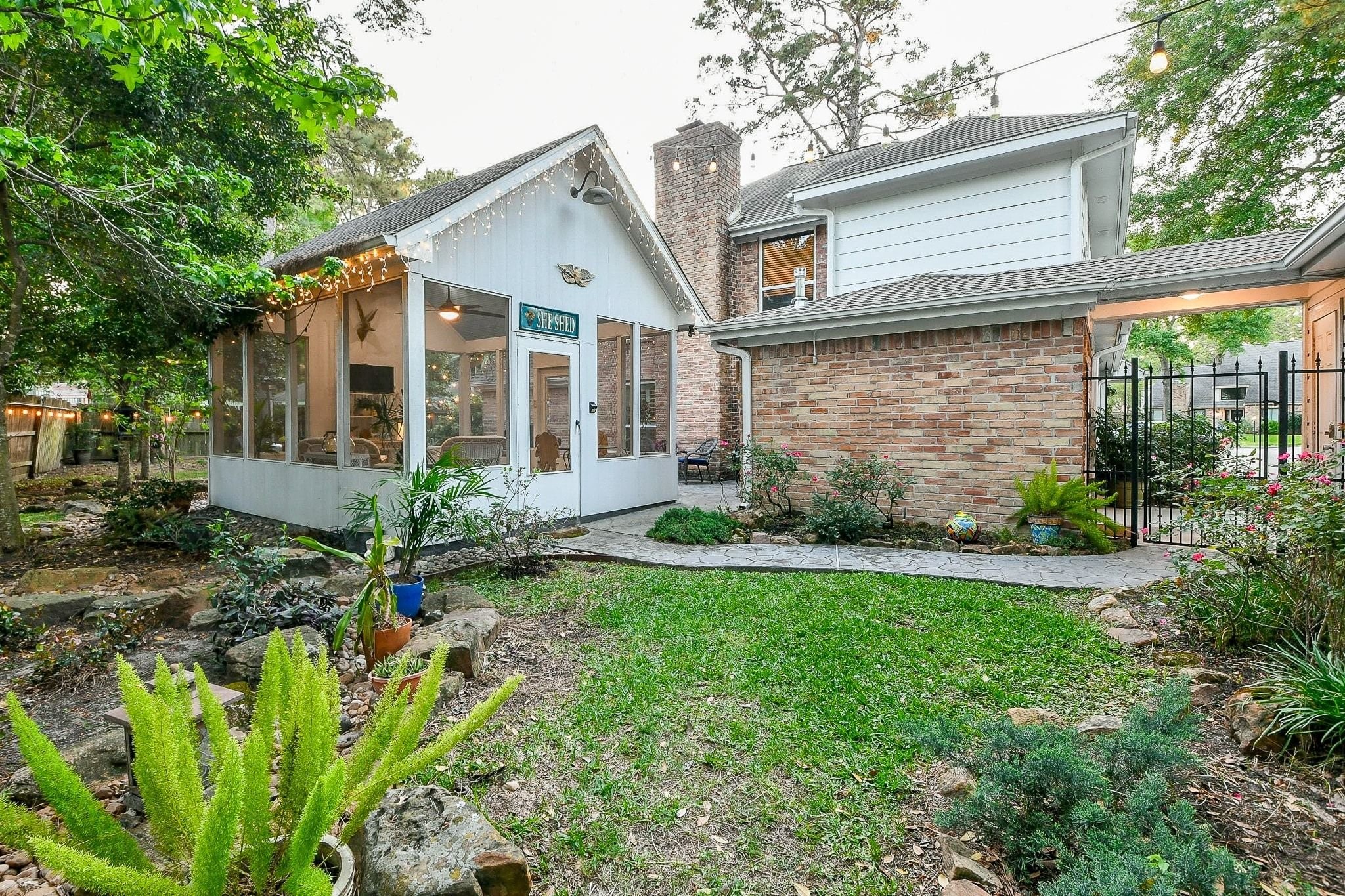 6607 Misty Springs Lane Spring, TX 77379 - Photo 31 of 31 Charming backyard view with lush greenery and inviting outdoor living space.