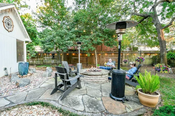 a view of a patio with chairs and plants