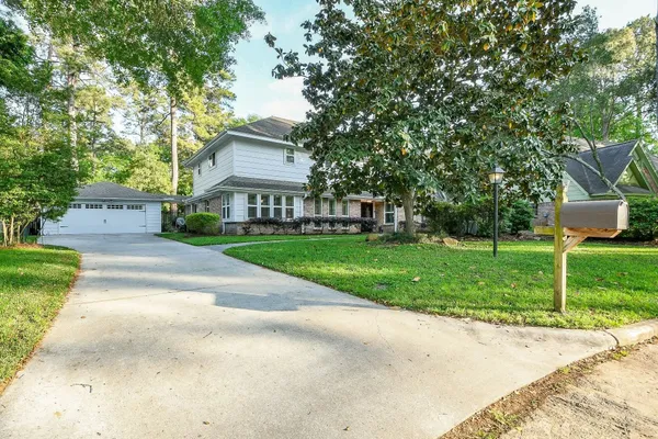 a front view of house with yard and green space